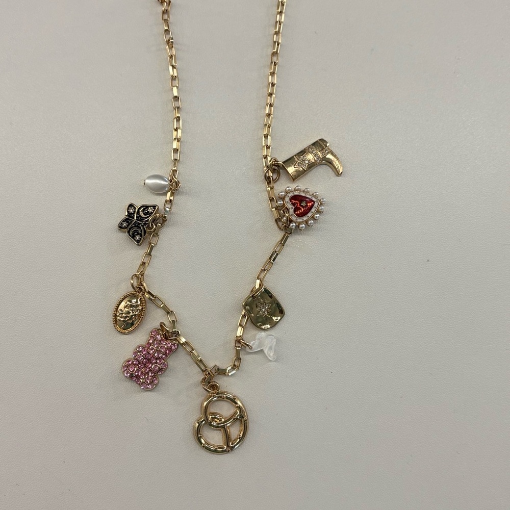 Francesca's Gold Charm Necklace with Pink and Red Details